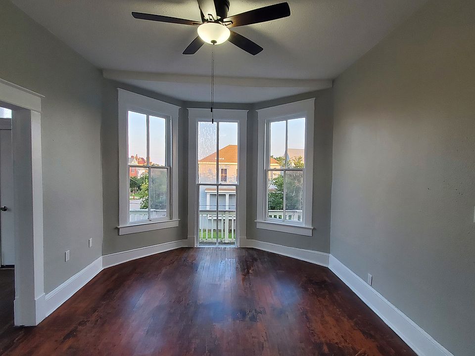 Galveston charm at it's best with a large living room and bay windows with a south-facing view