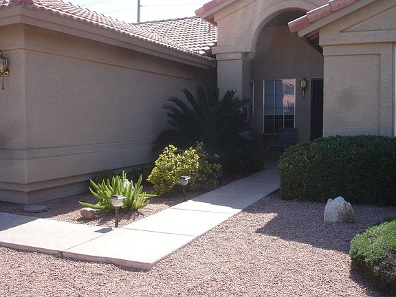 Lovely entry walk to front door. Attached two car garage is on left.