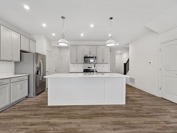Gourmet kitchen with tons of natural light, HUGE island and tons of cabinetry