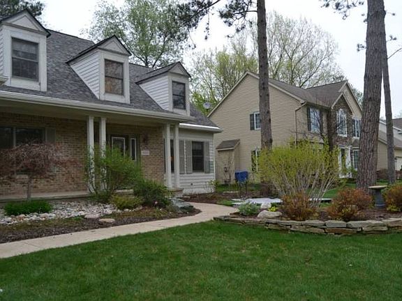 The front walk way from the driveway leads up to the front entrance and is beautifully landscaped.  Many plantings that will bring a smile to your face every spring.