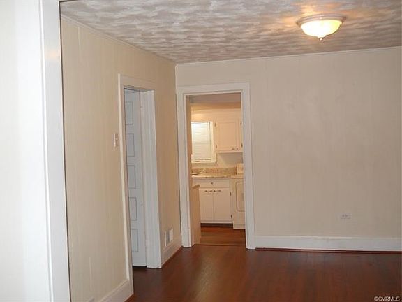 View from dining area into kitchen. Master Bedroom is located on the left.