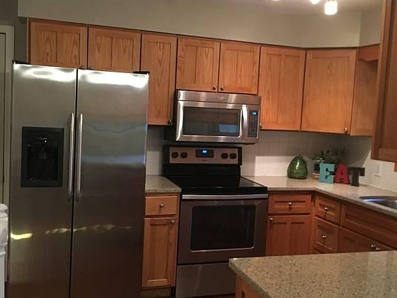 Modern kitchen with stainless steel appliances and granite counters