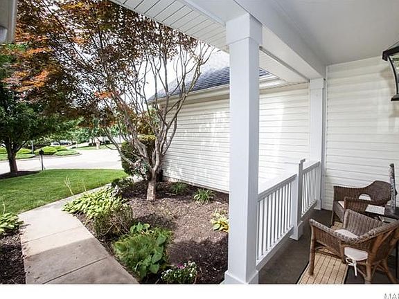 Beautiful planting garden and cozy front porch welcome you