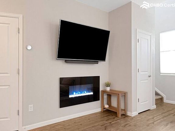 Living Room - large TV, sound bar, and electric fireplace