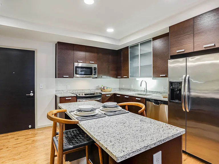 Kitchens with stainless steel appliances, espresso cabinets, and autumn white Brazilian granite countertops