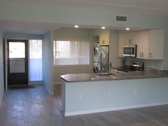 The main entrance, and easy reach kitchen, amenities include: convection-oven, over-the-range microwave, side by side refrigerator, with water and ice dispenser, clothes washer and dryer.