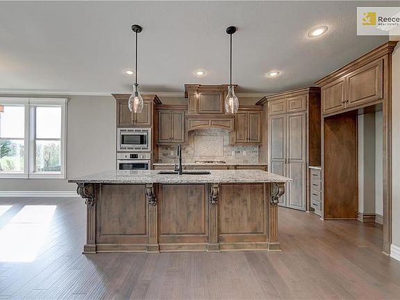 Designer chefs kitchen includes black silgranite or stainless double bowl sink with designer Kohler faucet with sprayer. Choice of custom wood or stainless steel exhaust hood.