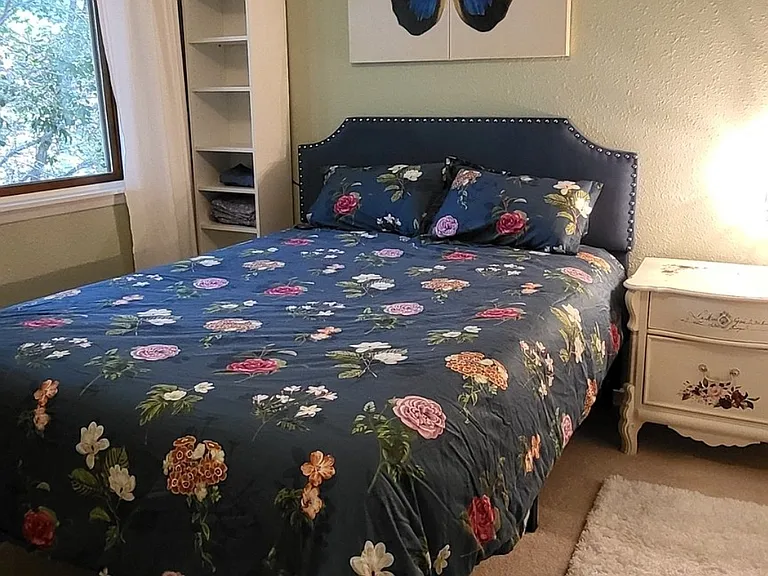 Guest room has queen bed, work space with desk and office chair, dresser, T.V. and closet.