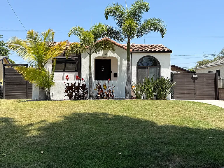 Front of house with a covered entry porch and a long private driveway with an automatic remote-controlled gate.