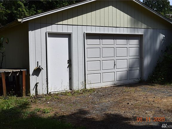 detached garage with work area and workbench.