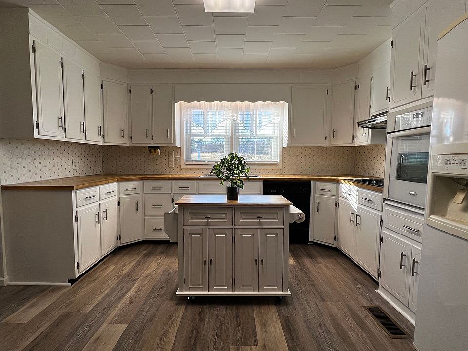 Big, bright, beautiful kitchen! Fully equipped with island, lots of counter space, confection oven, counter-top stove, refrigerator w/ ice & water in the door. Window at stainless steel double sink overlooks blue bird house and 2 acres of green space.