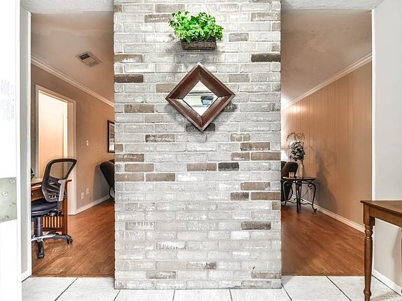 You;re greeted by a dramatic brick entry feature.