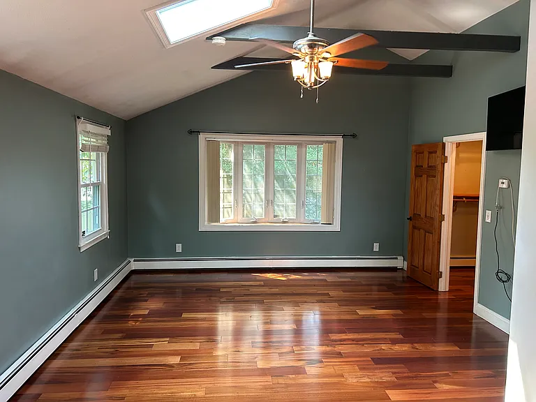 Large primary bedroom with vaulted ceiling and sky light. (1 of 4 bedrooms)