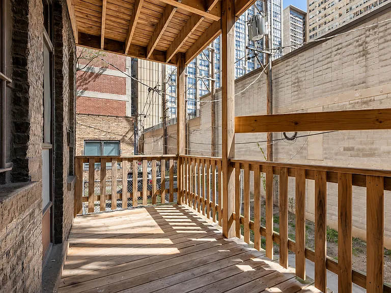 Balcony extending from the kitchen. Faces East. No public alley as the back yard area is private to the bldg