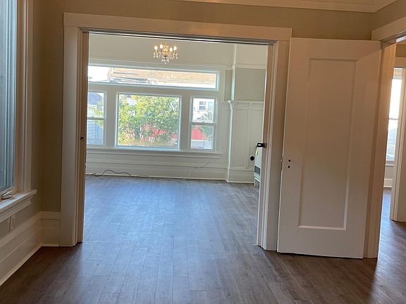 Bedroom looking into living room (there are sliding pocket doors that close)