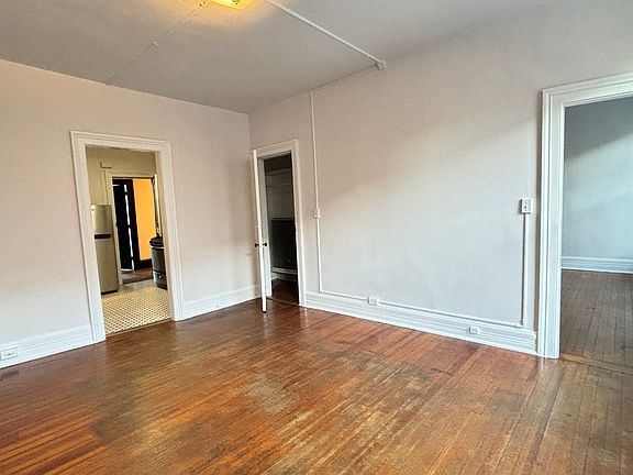 Living Room with Kitchen (l) and Bedroom (r) Center door is a large closet.