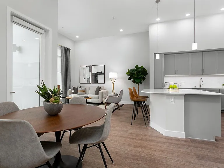 Apartments with hard surface flooring in kitchen, living, and dining areas