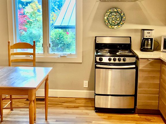 A large kitchen window looks out onto a courtyard garden.