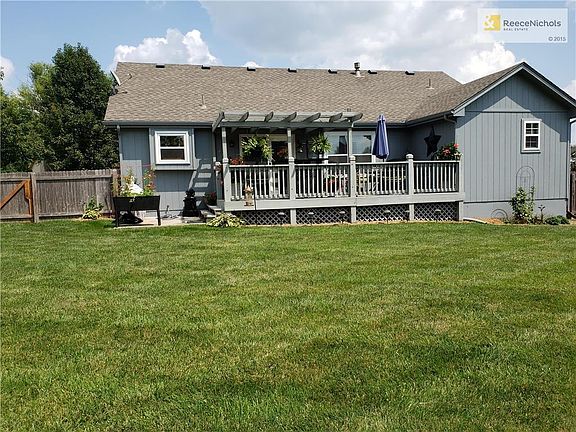 REAR OF HOUSE W/DECK & PATIO
