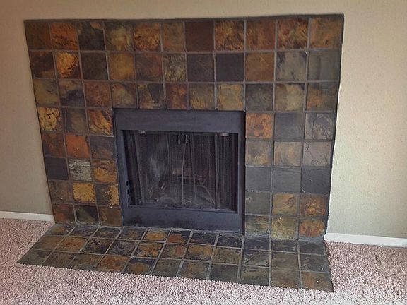 Closer view of the fireplace highlights the beautiful contrast between the slate stone and designer 