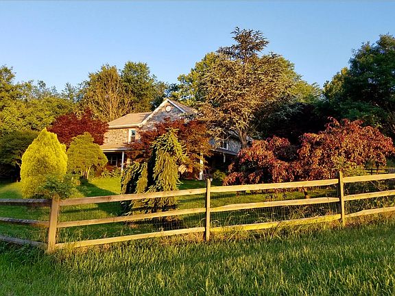 Beautifully landscaped 1 acre yard surrounded by fencing,.