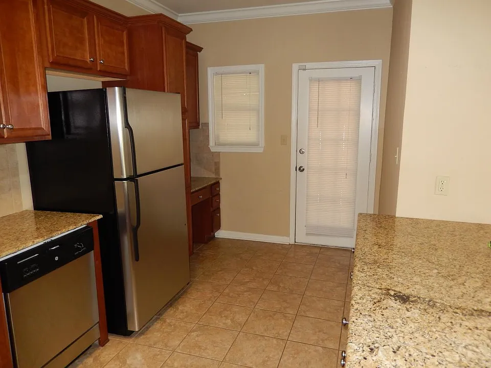 Desk area in kitchen; door leads to back screened porch