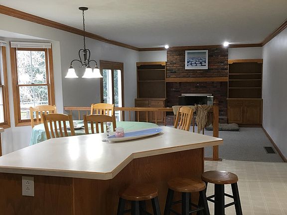 View from island breakfast bar and eat-in kitchen to family room