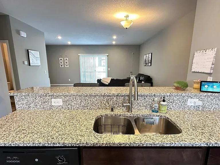 Elevate your lifestyle with the modern elegance of LS Capital Group. This open-concept kitchen features stunning granite counters and views that invite you to unwind. See how this space can transform your daily living. Ready to make a move?