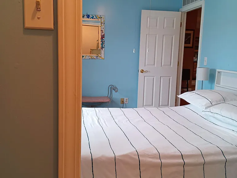 Spare bedroom east view with door leading to kitchen or spare bath entrance