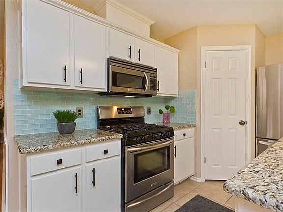 The kitchen features a center island, granite counters and stainless appliances.