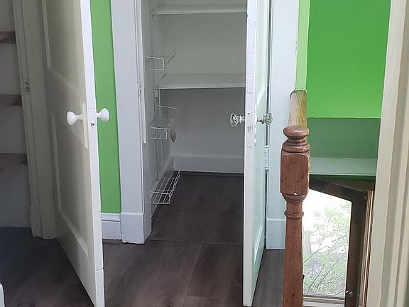 Standing in the kitchen looking into two closets for the kitchen.