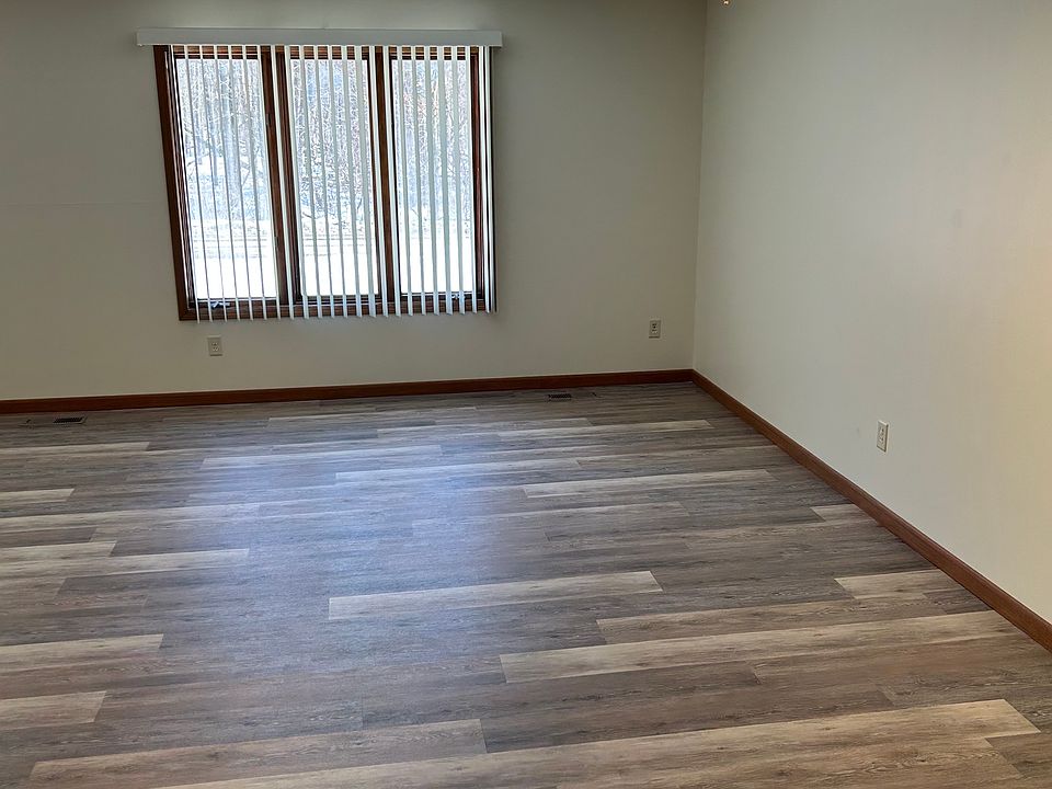 View of the family room area from the kitchen. The front door is to the left of that main window.