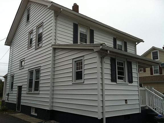 Back of house with mudroom and directly outside is a fenced 