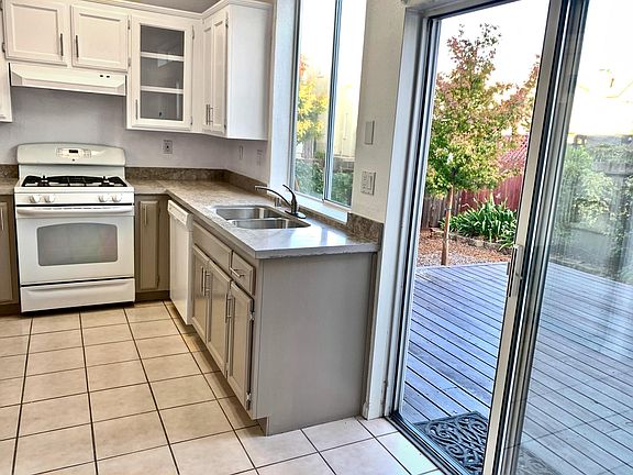 Updated kitchen with new quartz counter tops and eat-in dining area. Sliding door leading to large deck and garden.