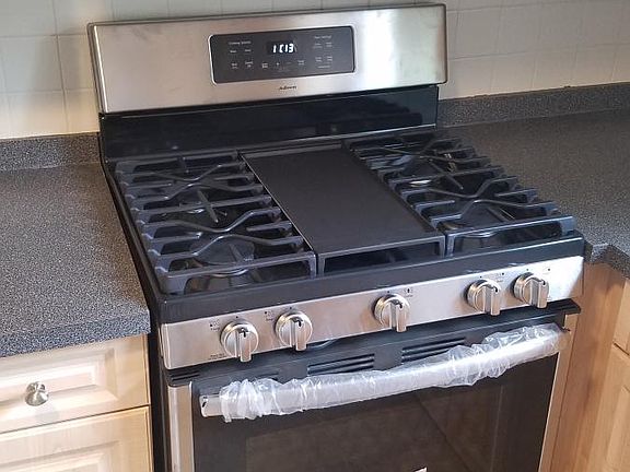 New stainless steel has stove and hood