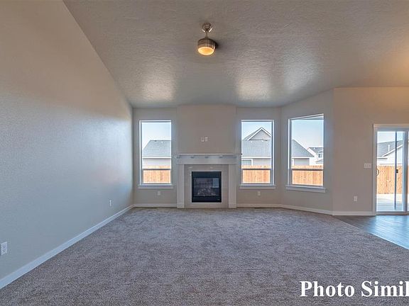 Great Room with Vaulted Ceilings, Gas Fireplace and Fan.