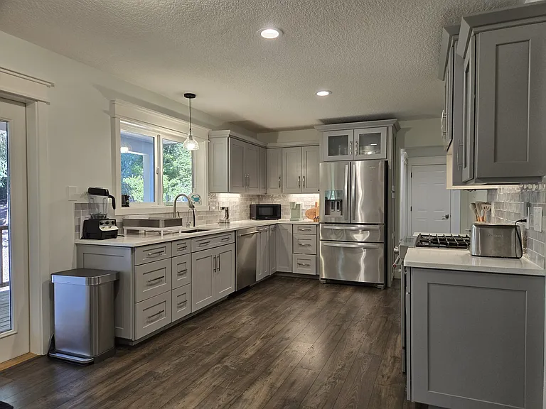 Upscale kitchen with stainless steel appliances, fully equipped with all utensils