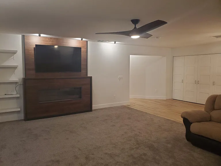 Shelves next to Smart TV. Smart TV and large sectional sofa included.