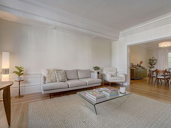 Grand but cozy living room overlooking Vallejo Street with soaring 12 ft ceilings and beautiful hardwood floors. There are also pocket doors from the living room to the dining room to close this room off, if needed.