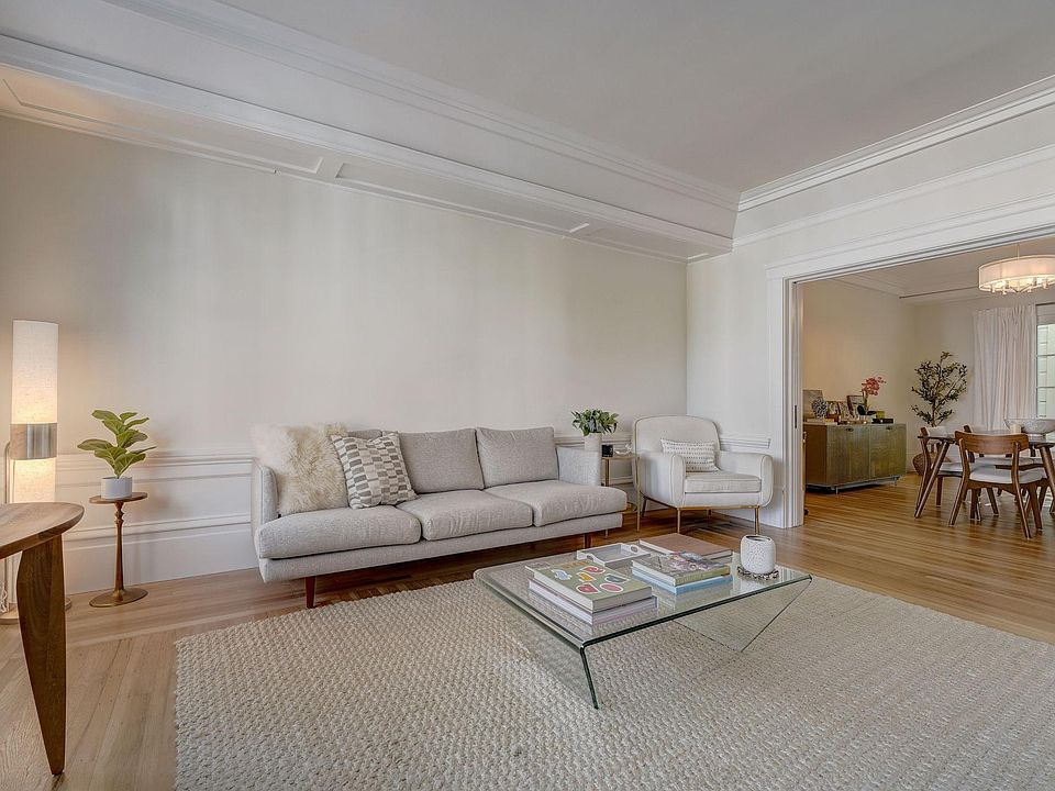 Grand but cozy living room overlooking Vallejo Street with soaring 12 ft ceilings and beautiful hardwood floors. There are also pocket doors from the living room to the dining room to close this room off, if needed.