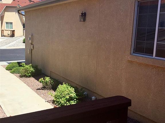 Small front deck patio, nicely manicured grounds done by the HOA