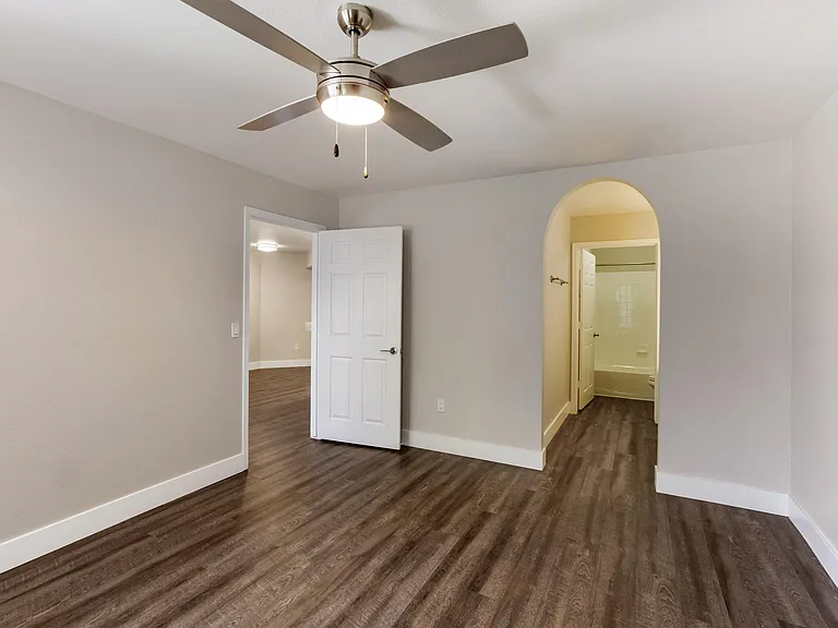 Indulge in the allure of hardwood floors and the gentle breeze of a ceiling fan in our cozy bedroom
