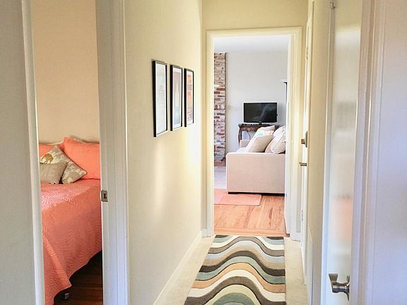 Hallway as seen from the kitchenette area. Entry closet and access to laundry area are from this hall as well.