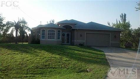 Front of the home. Features French Door to lead to the Courtyard, Privacy on the right and left with vacant lots. House sits back on the corner
