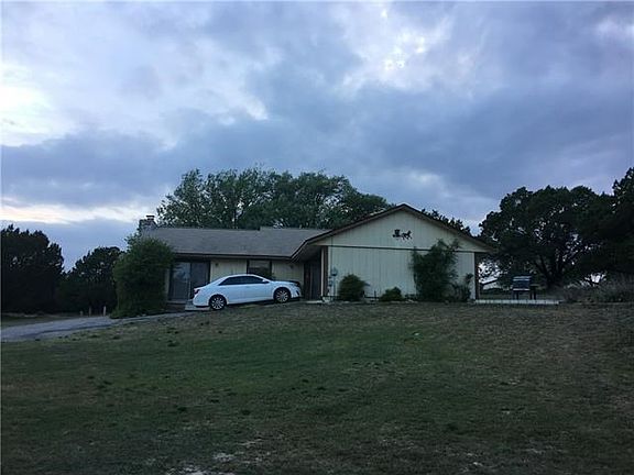 Back of house. Build an elevated deck over driveway to enjoy spectacular lake, golf course, and hill country views. See last two pictures for view from that elevation.