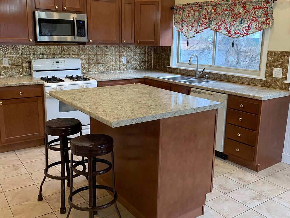 Huge kitchen, check out those lights; and that backsplash!