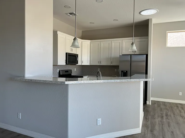 Counter Area with Plenty of Room for Bar Stools, 2 Pendant Lights, Downlight over Double SS Kitchen Sink