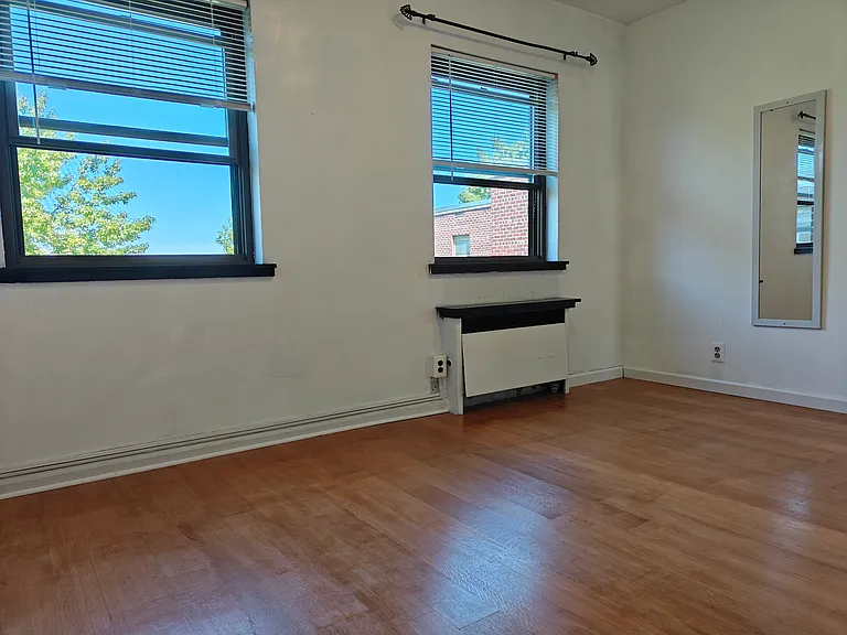 A bedroom with two bright windows.