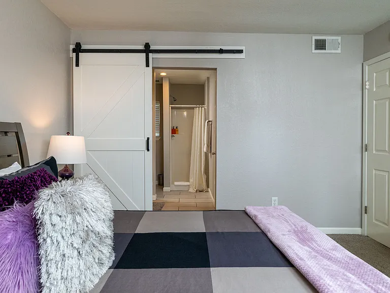 Bedroom 2 with king bed and door to patio with attached bathroom.