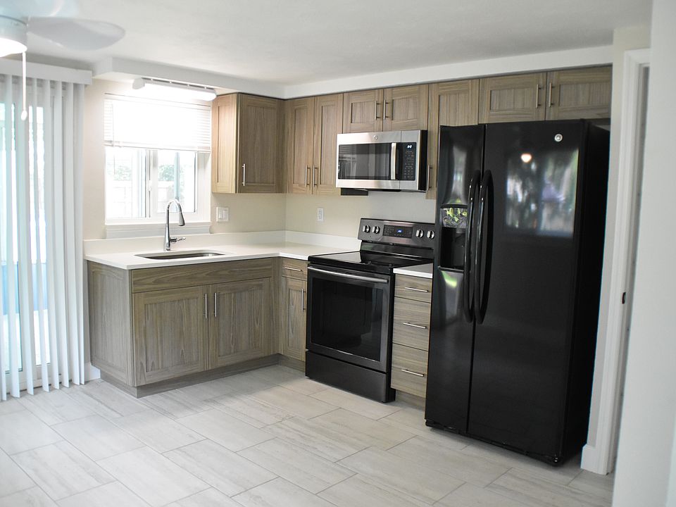 New kitchen cabinets and solid quartz countertops, oven, refrigerator, and microwave